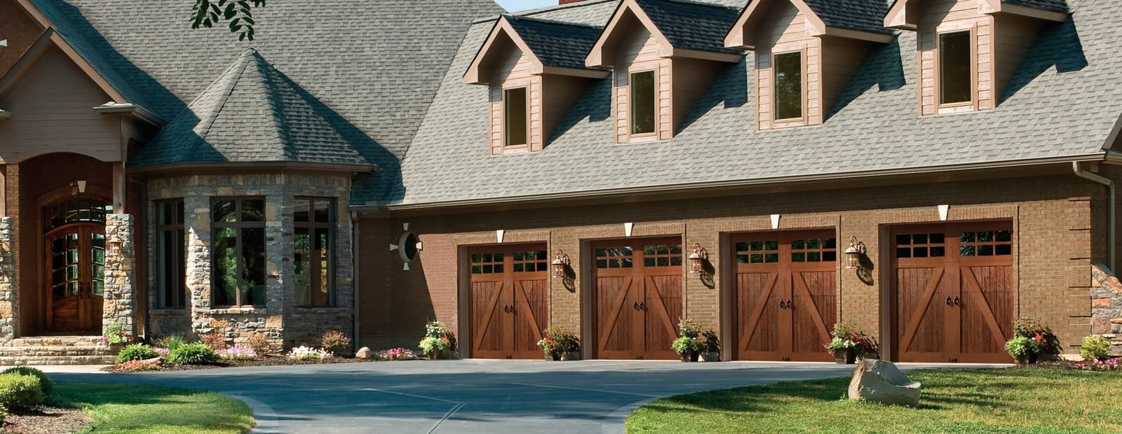 Canyon Ridge wood garage doors on a large home