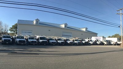 Liberty Door & Awning service truck fleet outside the warehouse